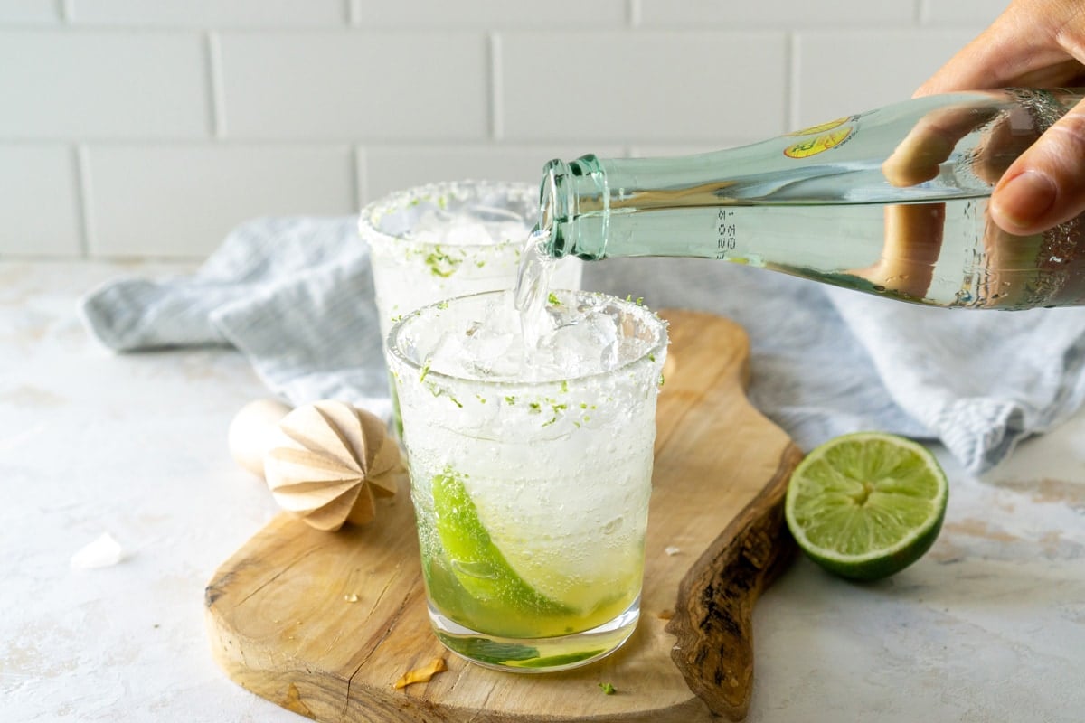 pouring mojito over ice 