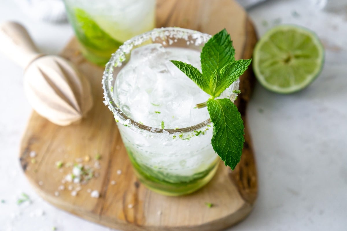 Angle of homemade mojito on wood cutting board 