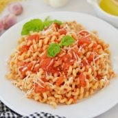 close up of pomodoro sauce over pasta in a bowl