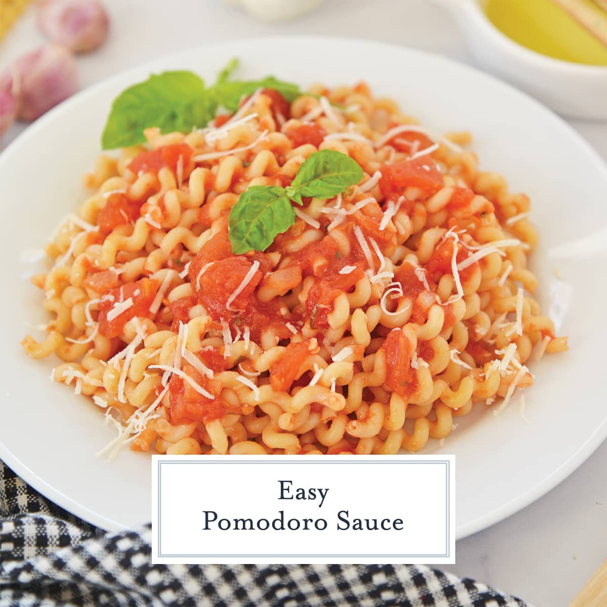 curly pasta in a bowl with pomodoro sauce with parmesan cheese and fresh basil