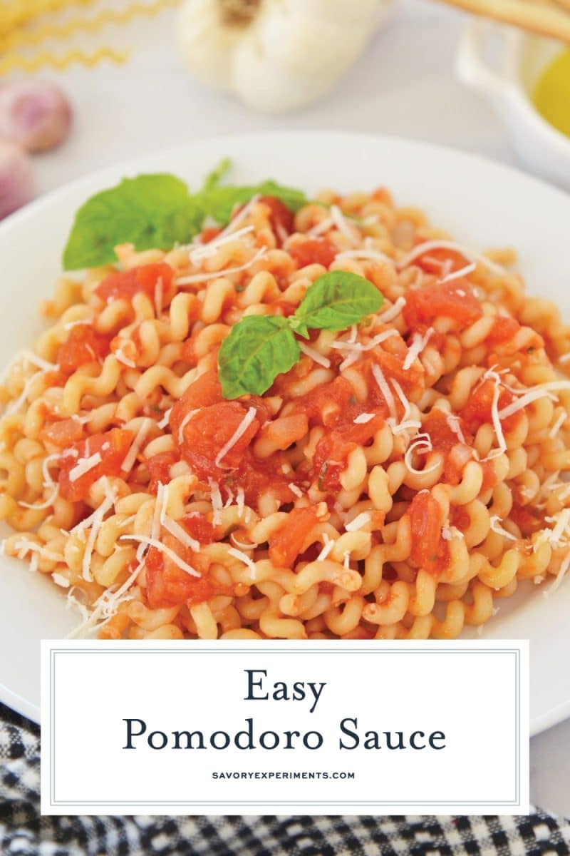 bowl of curly pasta in pomodoro sauce with fresh basil