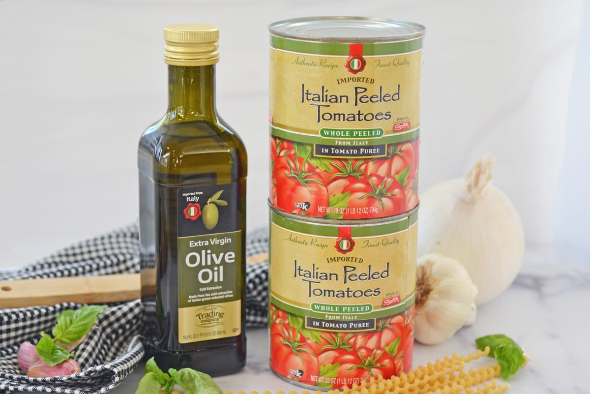 front image of canned tomatoes and olive oil 