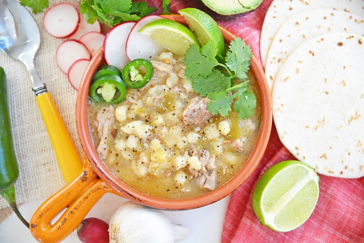 overhead of pork pozole with garnishes 