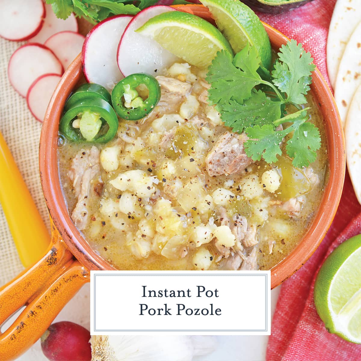 garnished pork pozole in orange bowl 