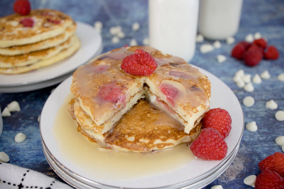 piece missing from pancake stack on white plates 