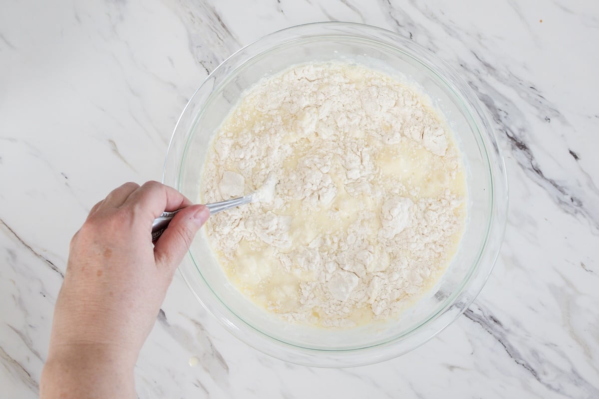 Mixing wet and dry ingredients in pancake batter 