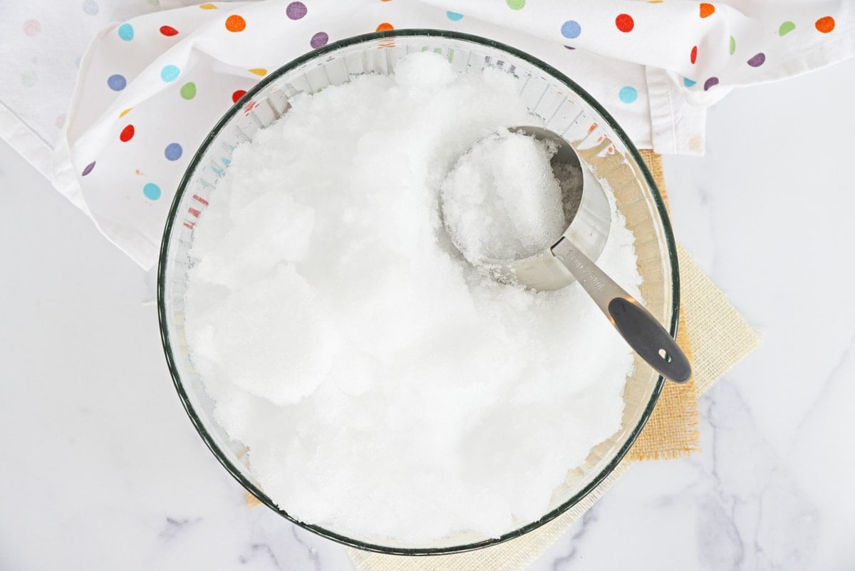 bowl of fresh snow with a measuring cup 