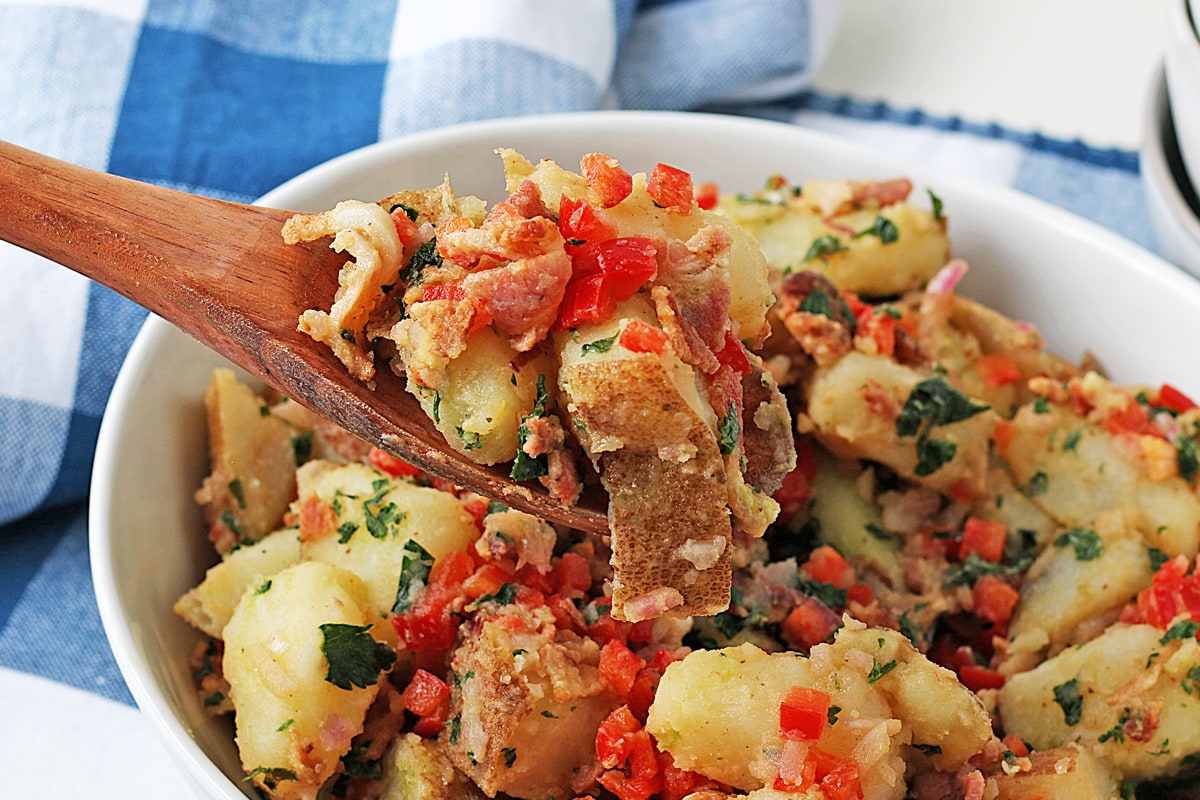 wooden spoon with homemade mustard potato salad 