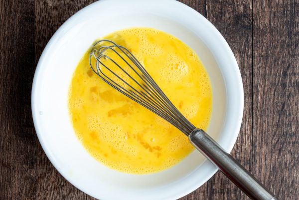 whisked eggs in a white bowl