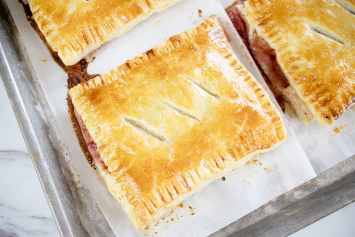 hand pies on a baking sheet with parchment 