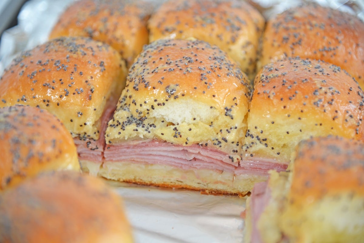 side angle view of ham and cheese sliders on a baking sheet 