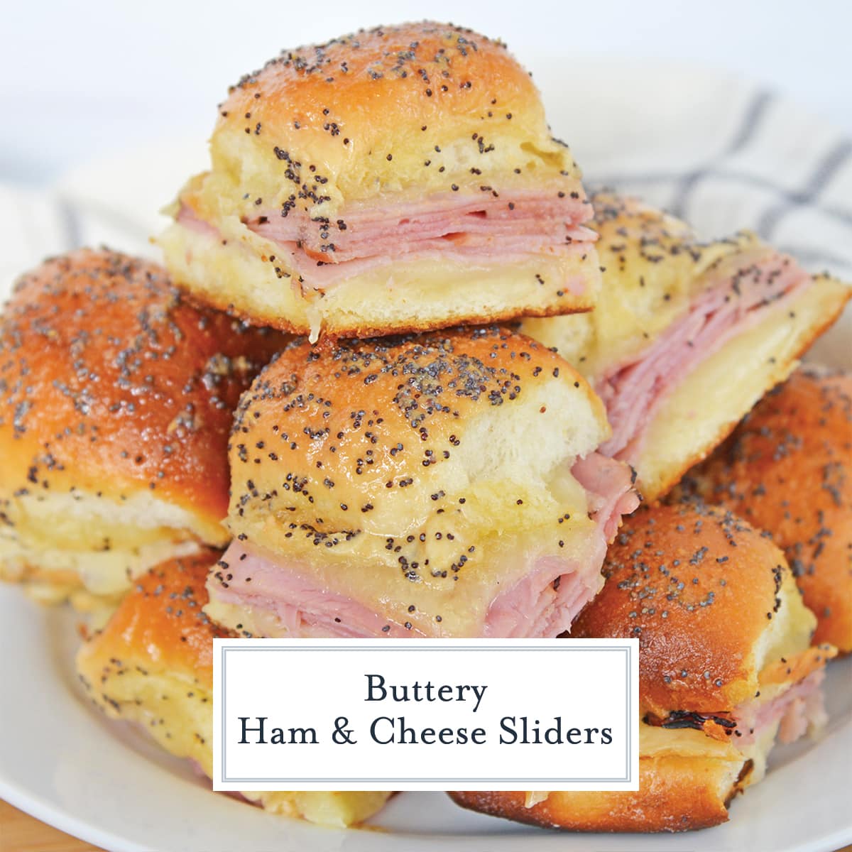 pile of butter ham sliders on a white plate 