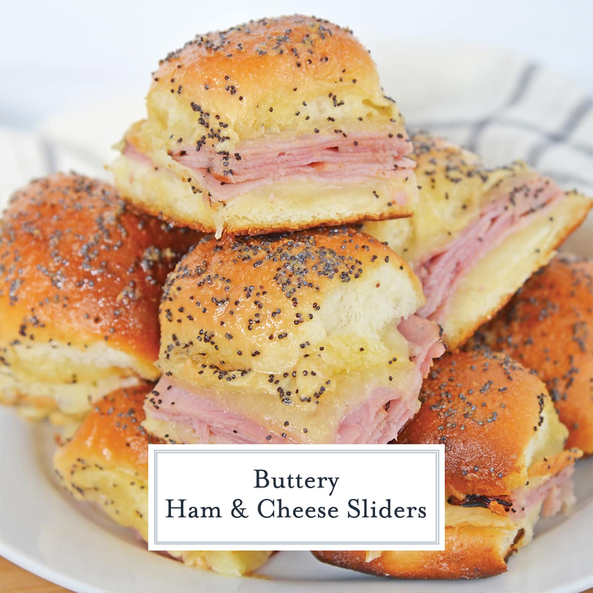 pile of butter ham sliders on a white plate