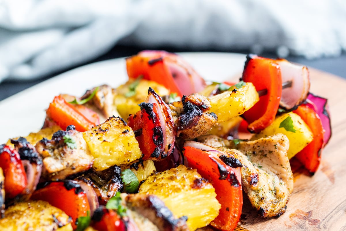 close up angle of chicken kabobs with pineapple, pepper and onion