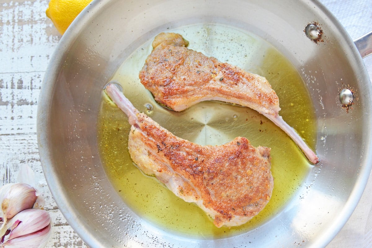 two lamb chops in a pan