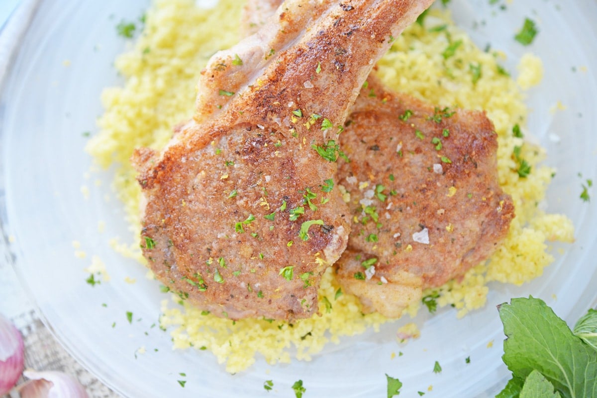 close up of seared lamb chops over mint couscous