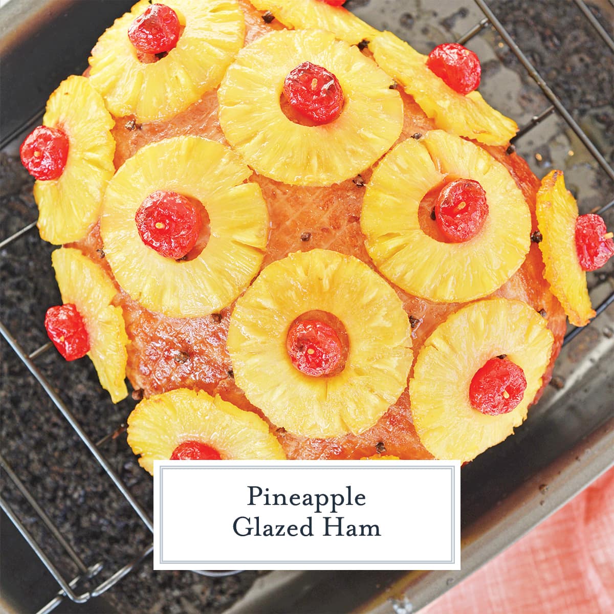 overhead of baked ham with pineapples and cherries 