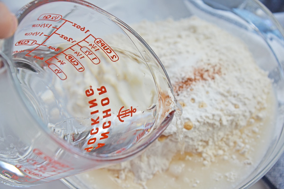 water pouring into sopapilla dough 