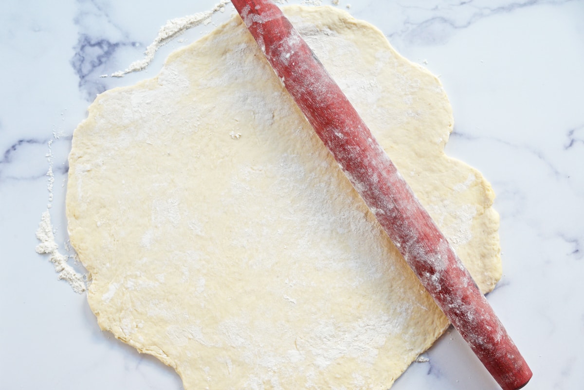 rolling out dough with a rolling pin 