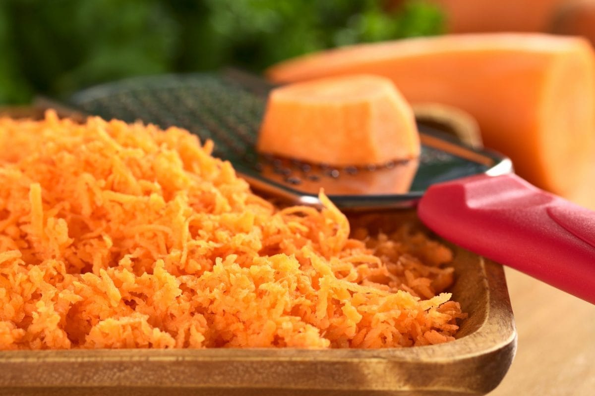 grated carrot on a wood plate 