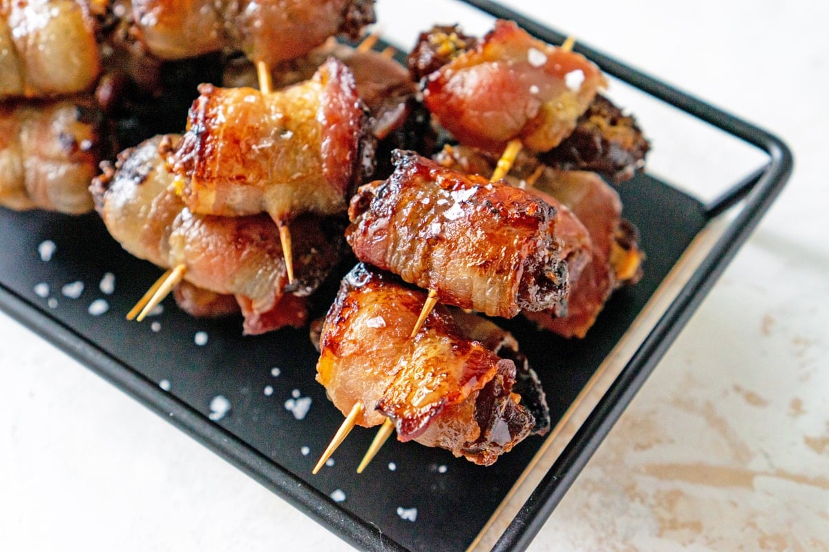 stuffed dates on a black serving platter