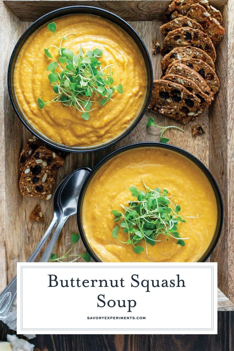 serving two bowls of garnished butternut squash soup 