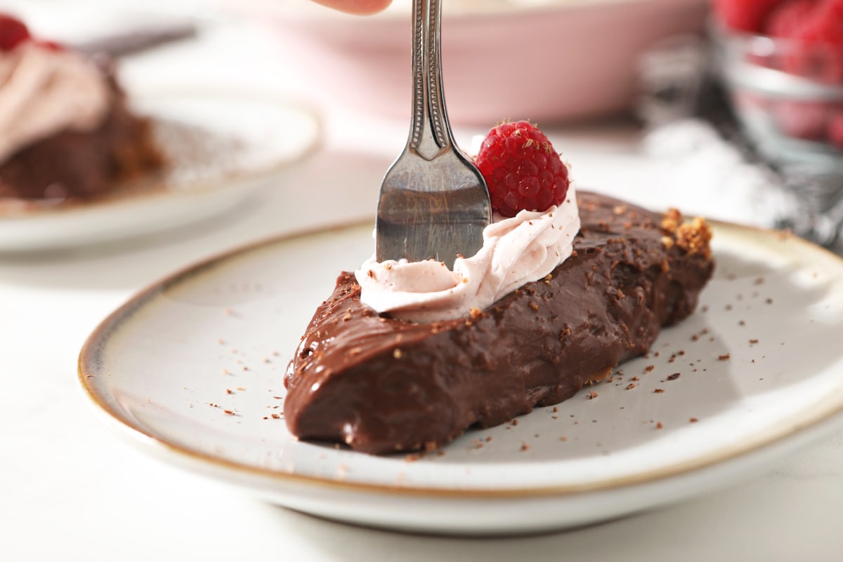 fork dipping into a piece of chocolate pie 