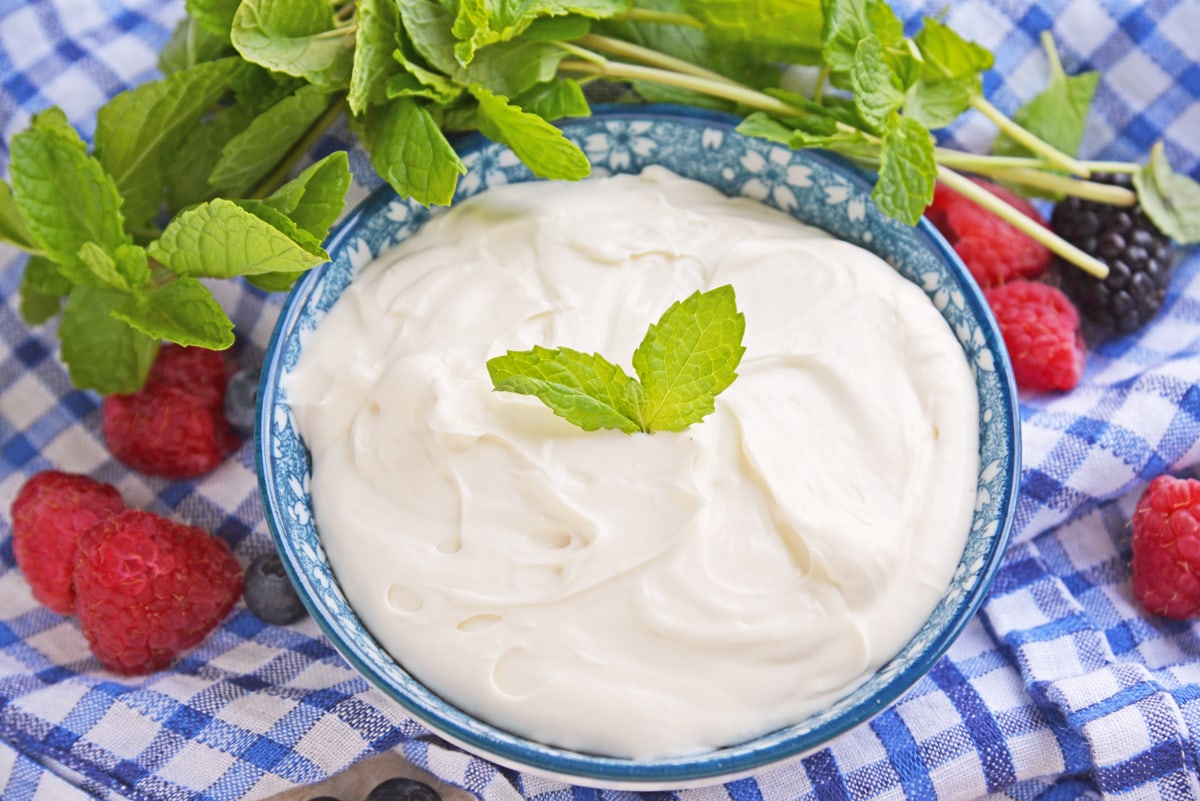 angled shot of cream cheese fruit dip in blue bowl