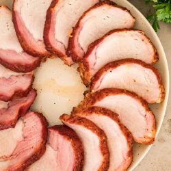 sliced pork loin arranged in a circle on a platter