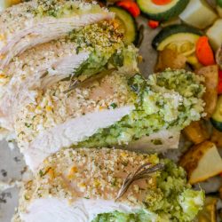 overhead shot of stuffed pork loin sliced with veggies