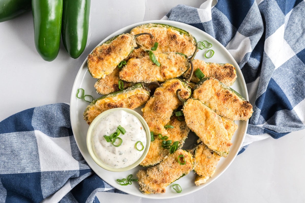 overhead of jalapeno poppers with white dip 