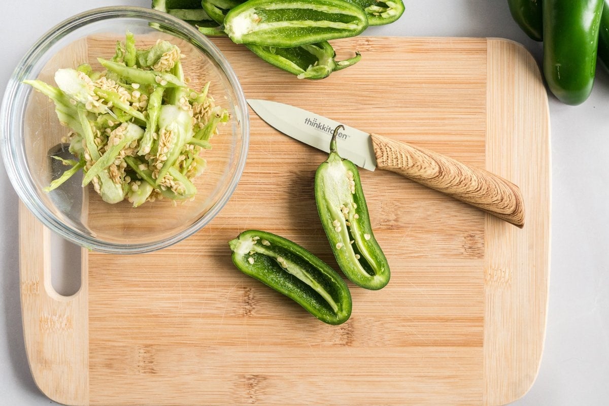 cutting jalapenos on wood cutting board 