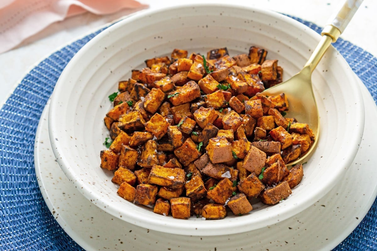 angle view of seasoned sweet potatoes in the oven 