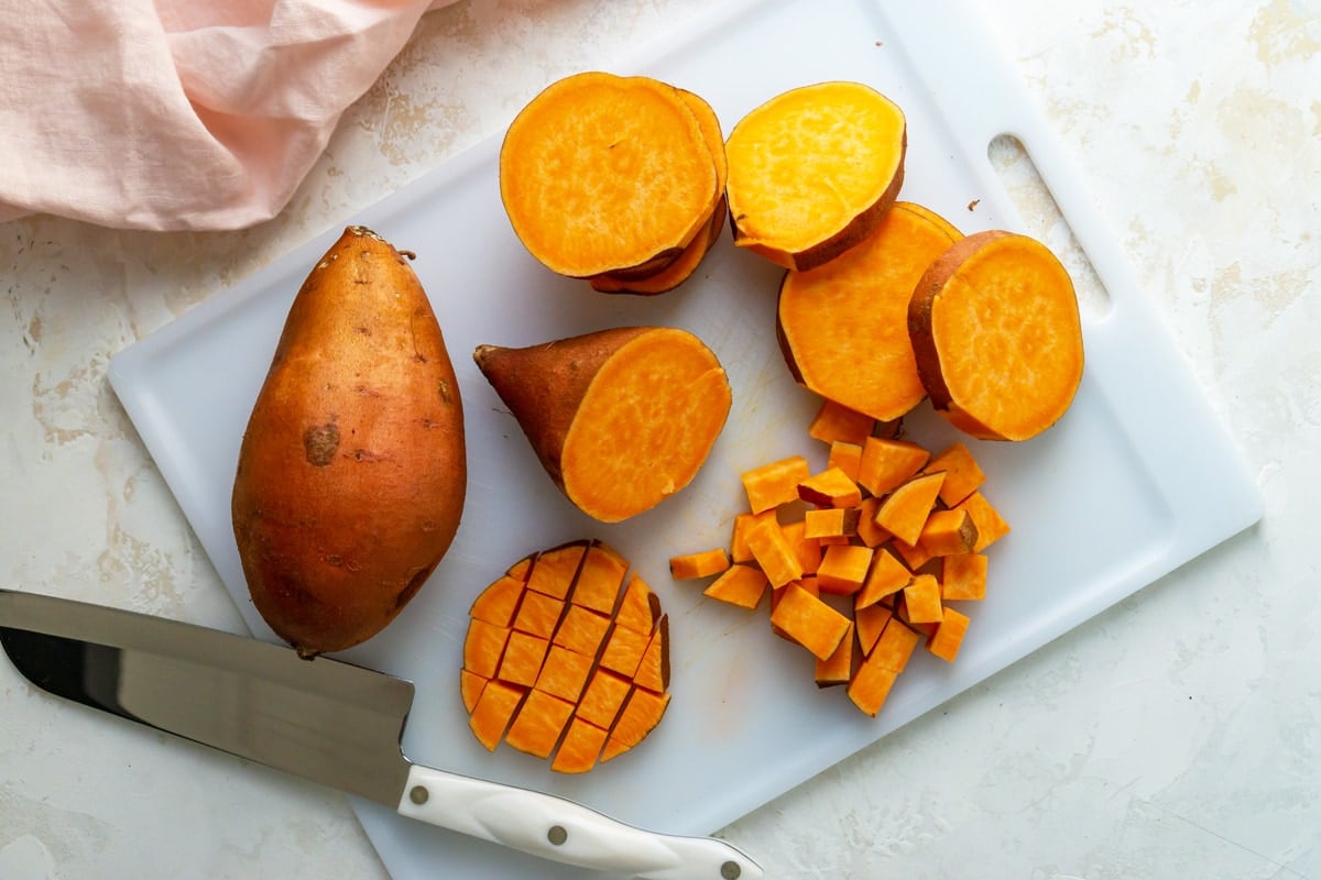 how to cut up a sweet potato on a cutting board 