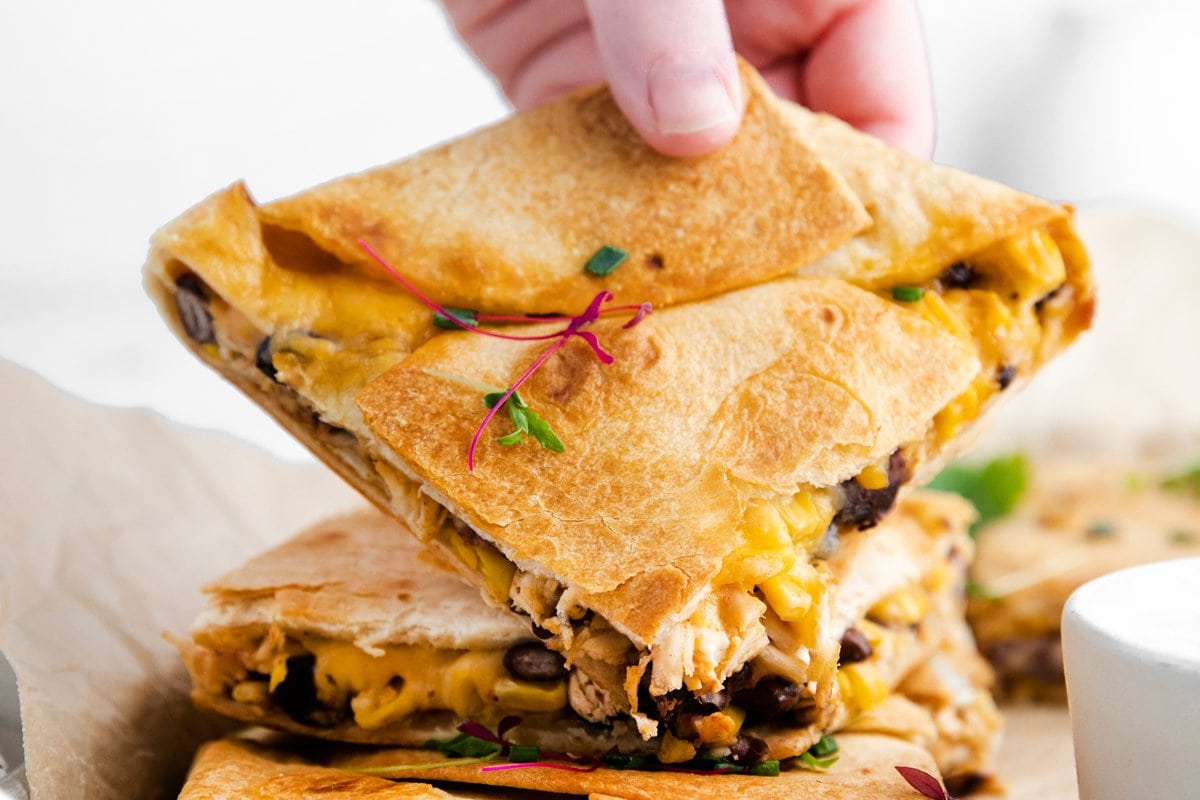 hand holding sheet pan quesadilla wedge 