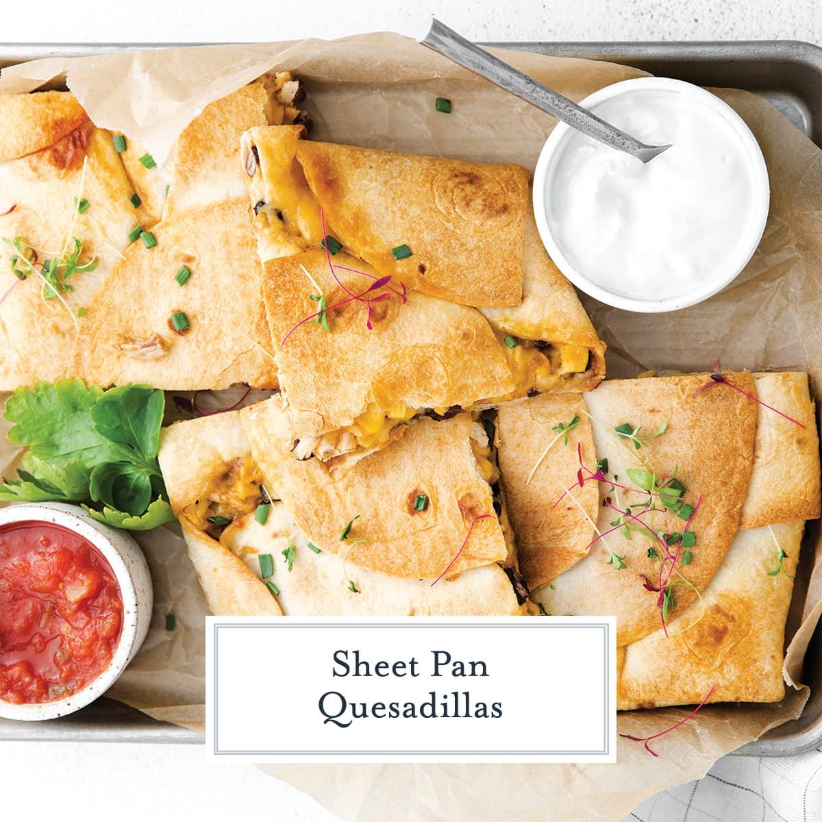 overhead of quesadillas in the oven with salsa and sour cream 