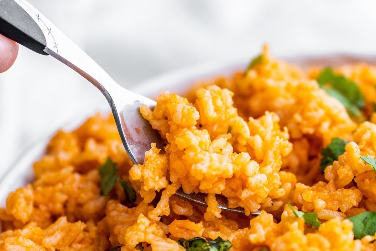 spoon digging into spanish rice 