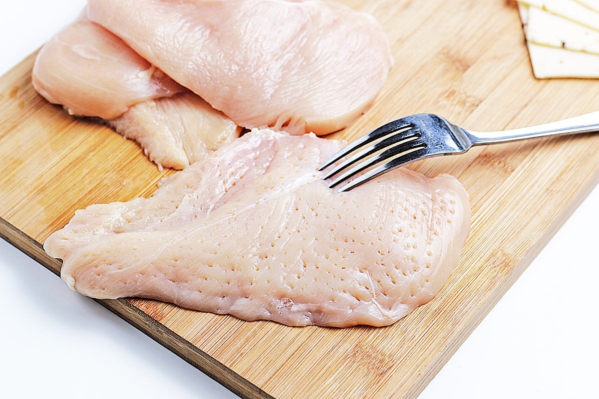 piercing chicken with a fork 