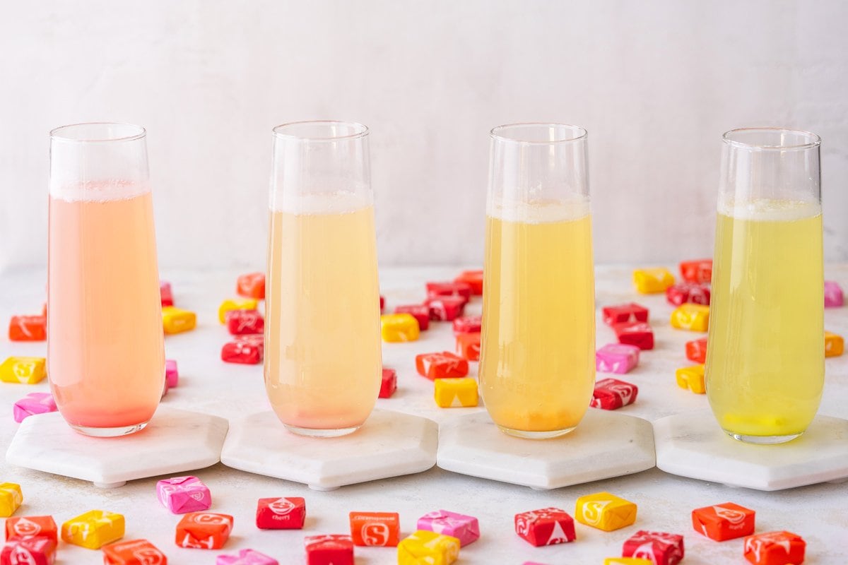 four champagne cocktails- pink, orange and yellows