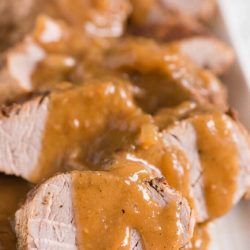 pork tenderloin slices covered in gravy