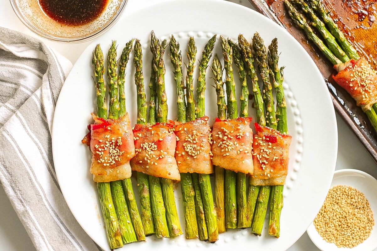 bacon wrapped asparagus on a serving plate 