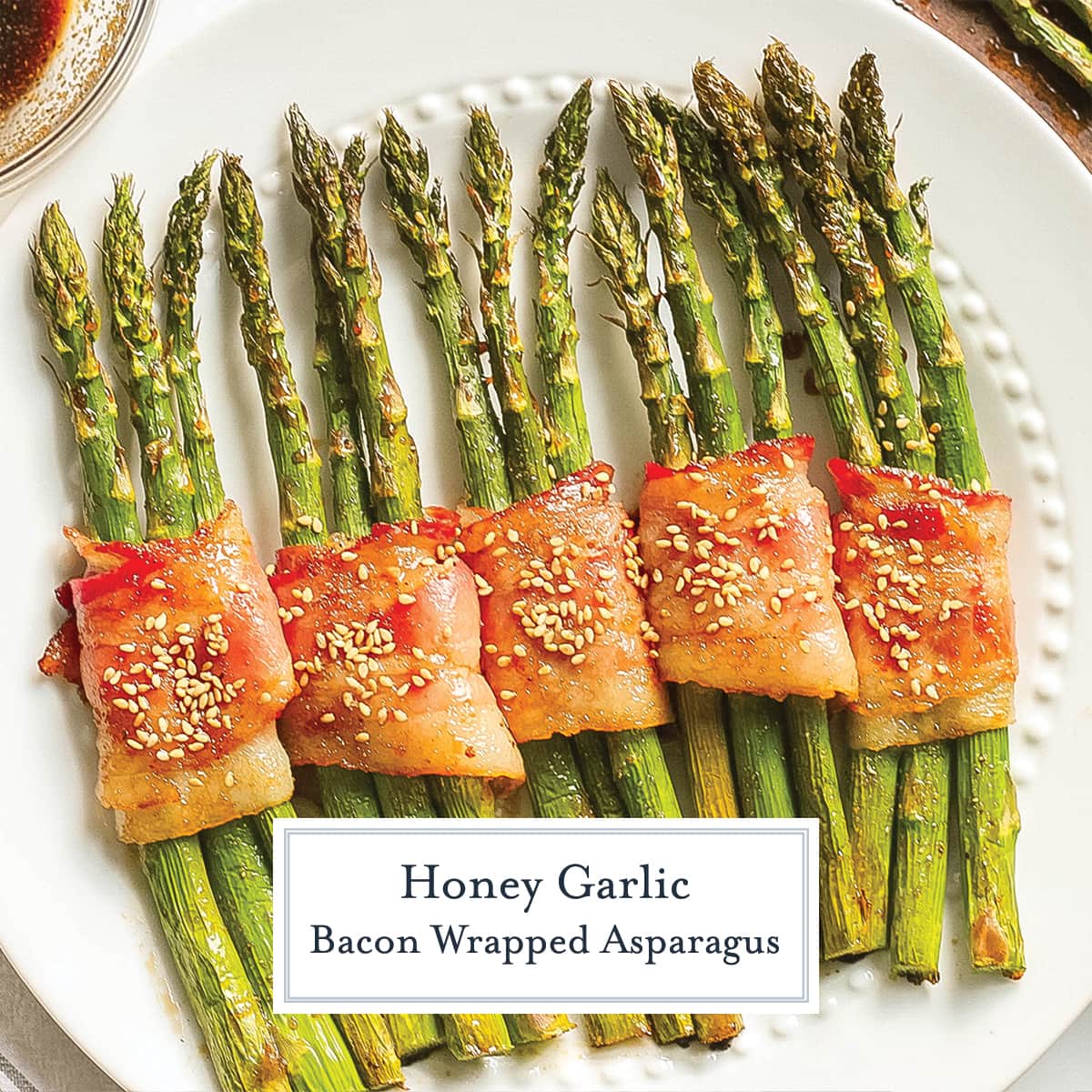 overhead of asparagus wrapped in bacon with sesame seeds 