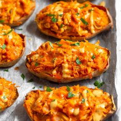 buffalo chicken stuffed sweet potatoes on a sheet pan