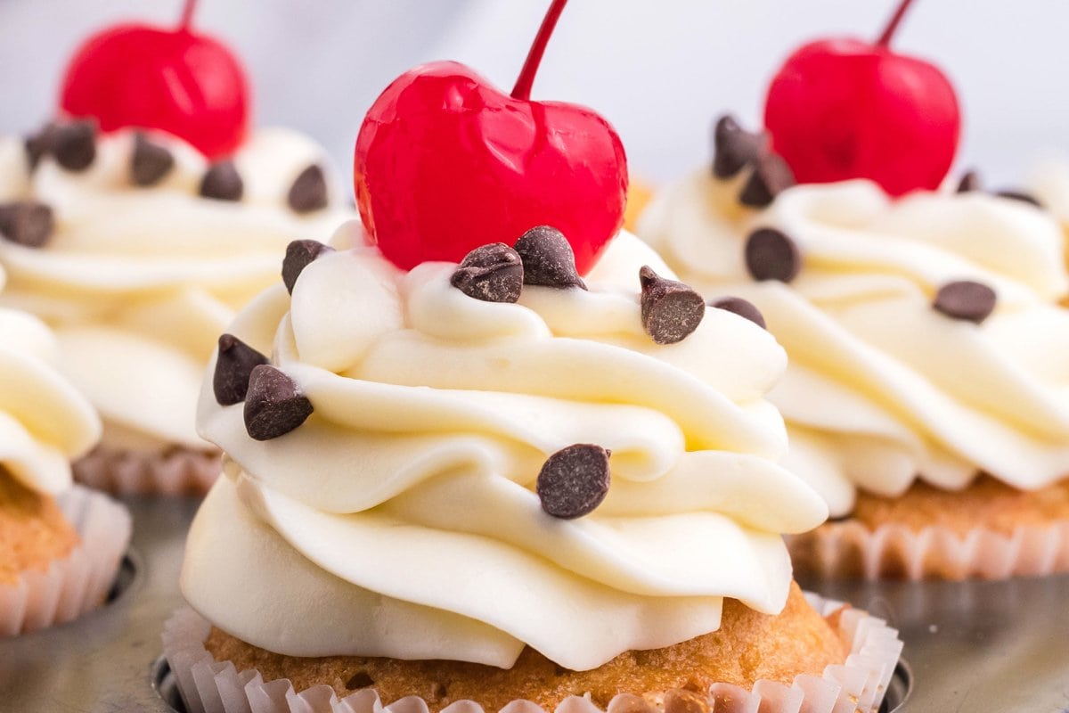 close up of piped cream cheese frosting on a cupcake 