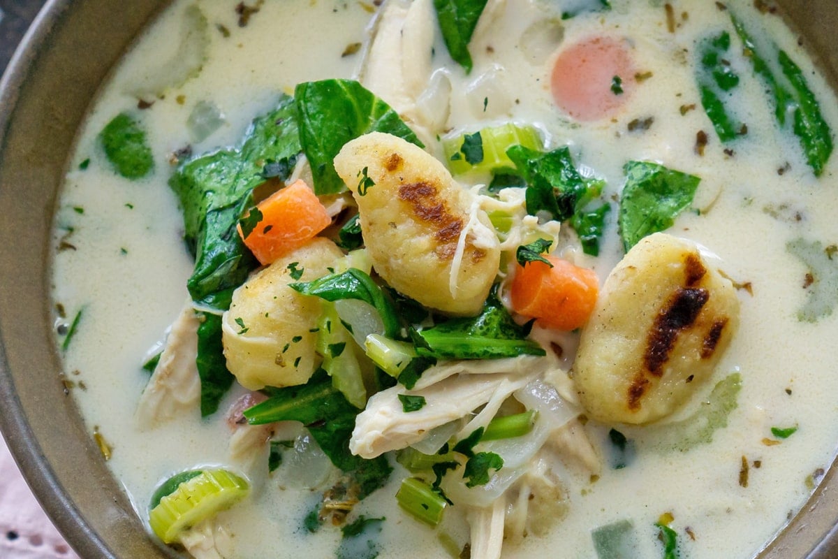 close up of browned gnocchi in soup 