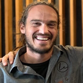 man smiling with gray button up shirt