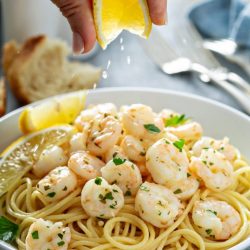 lemon squeezed over shrimp and pasta