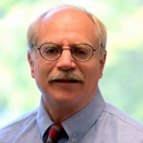 man with glasses wearing button up shirt