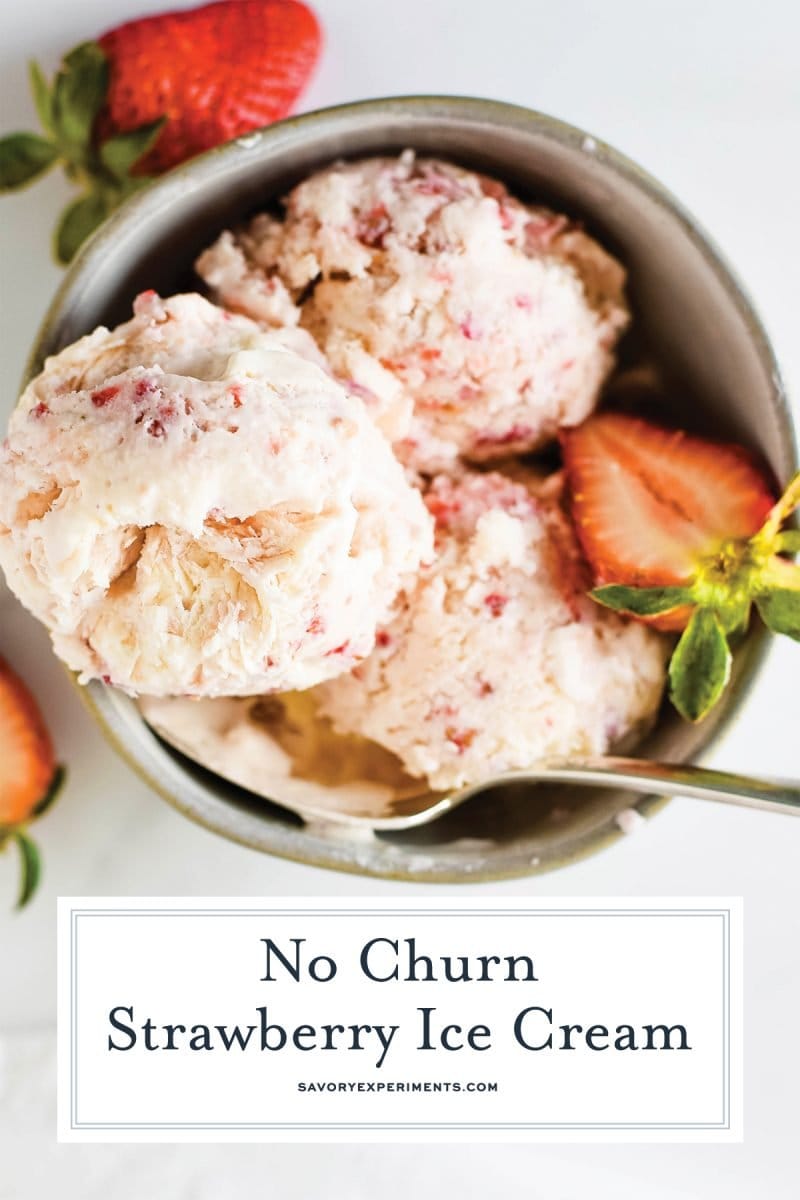 close up of strawberry ice cream in a bowl with fresh halved berries 