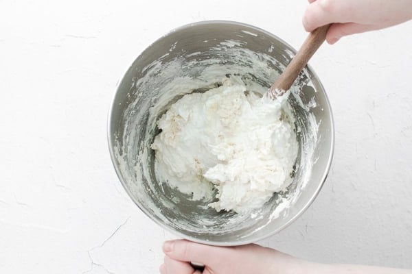 folding sugar and almond flour into meringue batter